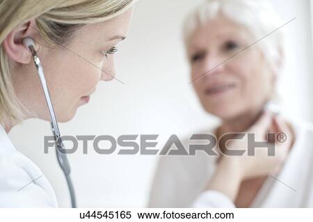 Stock Photography - Female doctor wearing stethoscope. Fotosearch
