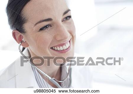 Stock Photography - Female doctor wearing stethoscope. Fotosearch