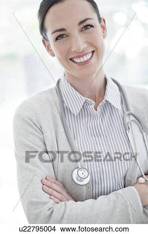 Female doctor with arms folded View Large Photo Image Picture - Female doctor with arms folded. Fotosearch