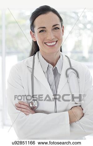 Stock Photograph - Female doctor with arms folded. Fotosearch