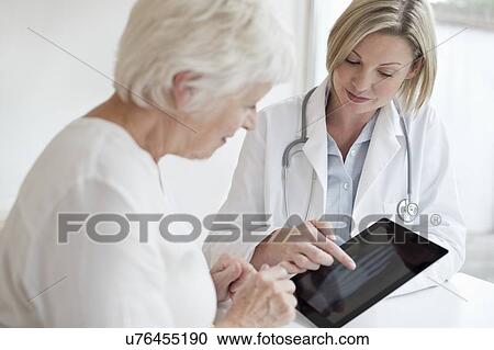 Stock Image - Female doctor with digital tablet. Fotosearch