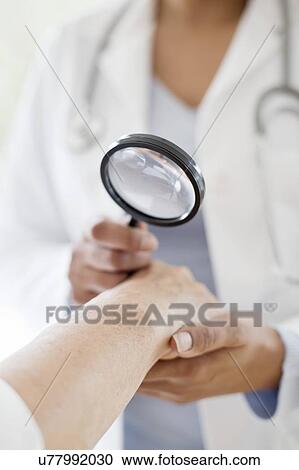 Female doctor with magnifying glass View Large Photo Image Stock Image - Female doctor with magnifying glass. Fotosearch