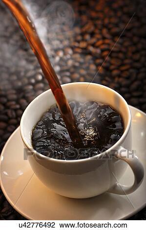 Stock Image - Fresh coffee being poured into cup. Fotosearch