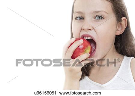 Girl biting apple View Large Photo Image Stock Image - Girl biting apple. Fotosearch