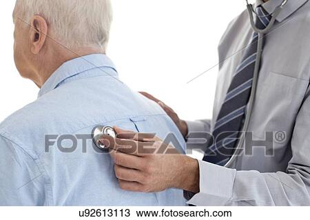 Stock Image - Male doctor examining patient. Fotosearch