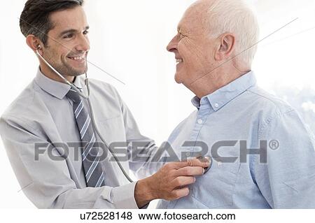 Stock Photo - Male doctor examining patient. Fotosearch