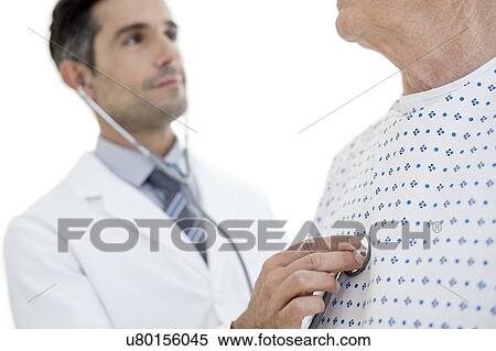 Male doctor examining patient View Large Photo Image Stock Photography - Male doctor examining patient. Fotosearch