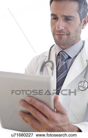 Male doctor using tablet View Large Photo Image Stock Photo - Male doctor using tablet. Fotosearch