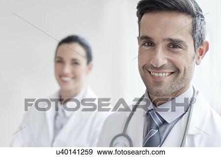 Stock Photo - Male doctor with female colleague. Fotosearch
