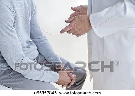 Stock Photography - Male doctor with patient. Fotosearch