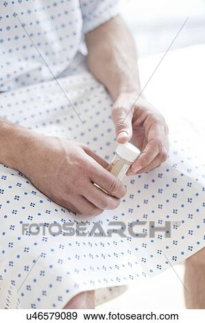 Male patient wearing hospital gown View Large Photo Image Stock Photo - Male patient wearing hospital gown. Fotosearch