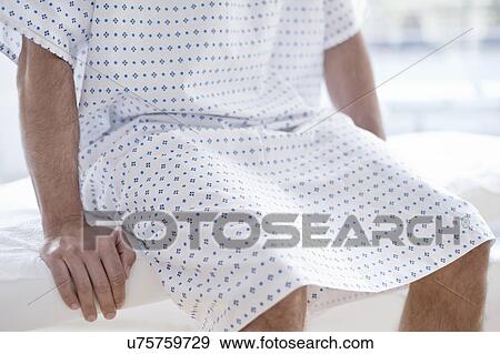 Male patient wearing hospital gown View Large Photo Image Stock Photo - Male patient wearing hospital gown. Fotosearch
