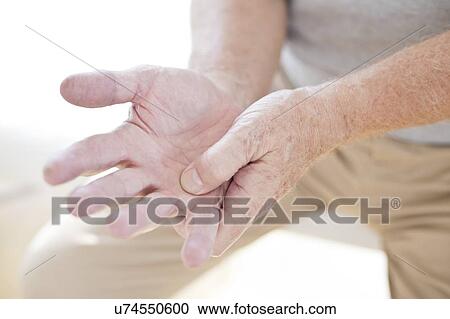 Man rubbing sore hand View Large Photo Image Stock Image - Man rubbing sore hand. Fotosearch