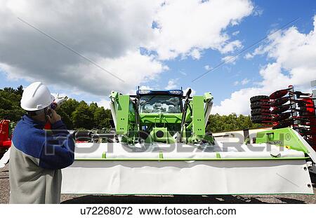 Mechanic with farming machinery View Large Photo Image Stock Image - Mechanic with farming machinery. Fotosearch