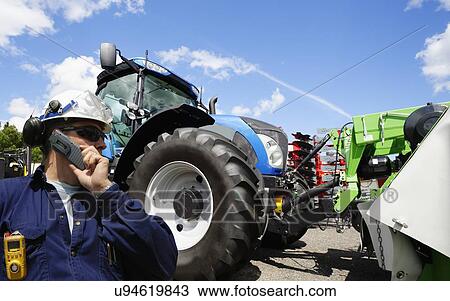 Stock Image - Mechanic with farming machines. Fotosearch