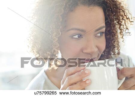 Mid adult woman drinking coffee View Large Photo Image Stock Photography - Mid adult woman drinking coffee. Fotosearch