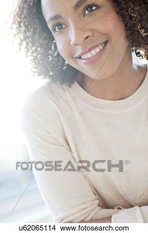Picture - Mid adult woman looking away. Fotosearch