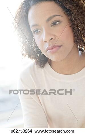 Mid adult woman looking away View Large Photo Image Picture - Mid adult woman looking away. Fotosearch