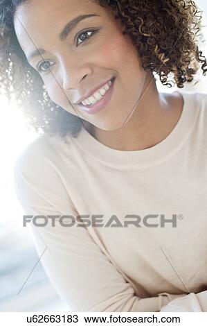 Stock Image - Mid adult woman looking away. Fotosearch
