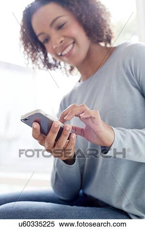Mid adult woman using phone View Large Photo Image Stock Photography - Mid adult woman using phone. Fotosearch