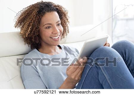 Mid adult woman using tablet View Large Photo Image Stock Image - Mid adult woman using tablet. Fotosearch