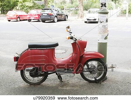 Moped parked by lamp post View Large Photo Image Stock Photo - Moped parked by lamp post. Fotosearch