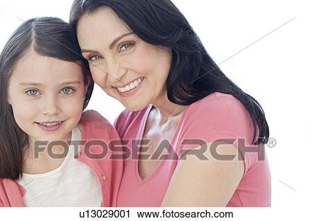 Stock Image - Mother and daughter smiling. Fotosearch