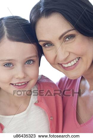 Stock Image - Mother and daughter smiling. Fotosearch