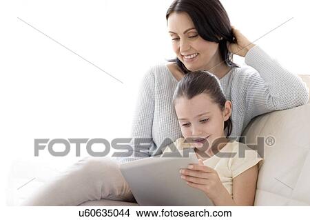 Picture - Mother and daughter with digital tablet. Fotosearch