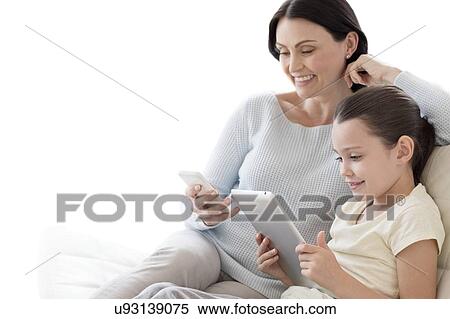 Stock Photography - Mother and daughter with tablet and phone. Fotosearch