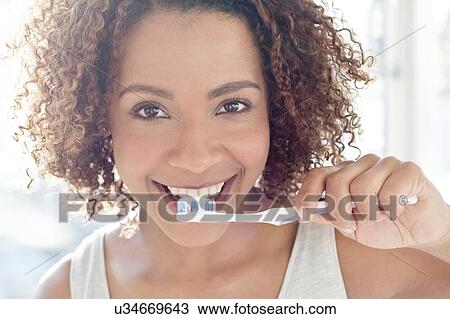 Portrait of woman brushing teeth View Large Photo Image Stock Image - Portrait of woman brushing teeth. Fotosearch