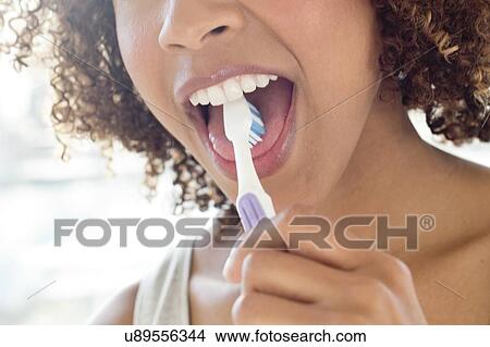 Portrait of woman brushing tongue View Large Photo Image Picture - Portrait of woman brushing tongue. Fotosearch