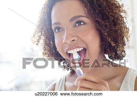 Portrait of woman brushing tongue View Large Photo Image Stock Photograph - Portrait of woman brushing tongue. Fotosearch