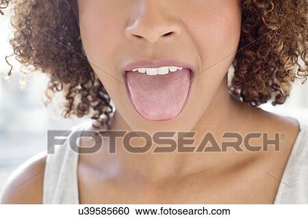 Portrait of woman sticking out tongue View Large Photo Image Stock Image - Portrait of woman sticking out tongue. Fotosearch