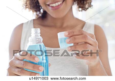 Portrait of woman using mouthwash View Large Photo Image Stock Image - Portrait of woman using mouthwash. Fotosearch