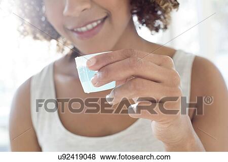 Portrait of woman using mouthwash View Large Photo Image Stock Photo - Portrait of woman using mouthwash. Fotosearch