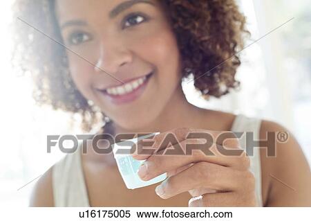 Stock Photography - Portrait of woman using mouthwash. Fotosearch
