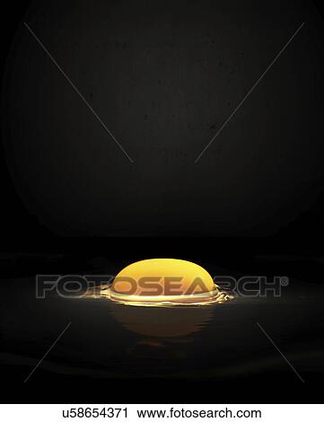 Stock Image - Raw egg yolk against black background. Fotosearch