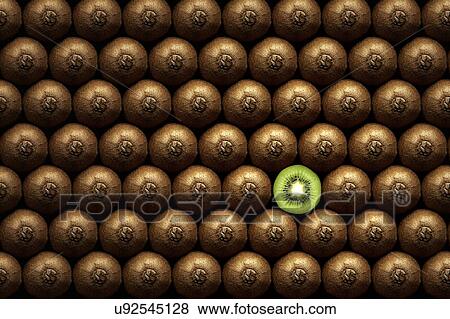 Stock Photo - Rows of kiwi fruit with one cut in half. Fotosearch