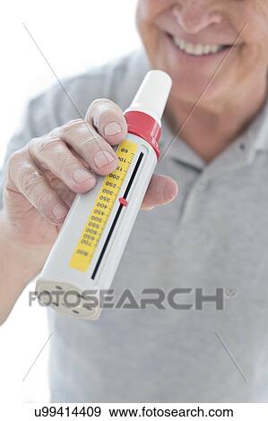 Senior man using peak flow metre View Large Photo Image Stock Photo - Senior man using peak flow metre. Fotosearch