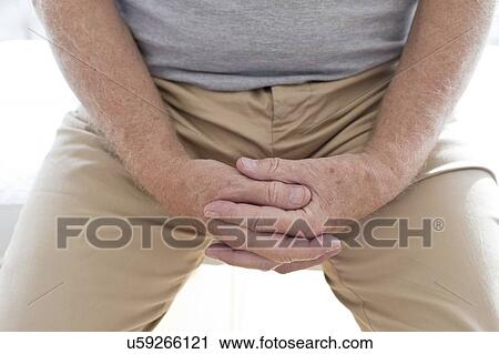 Stock Image - Senior man with hands clasped. Fotosearch
