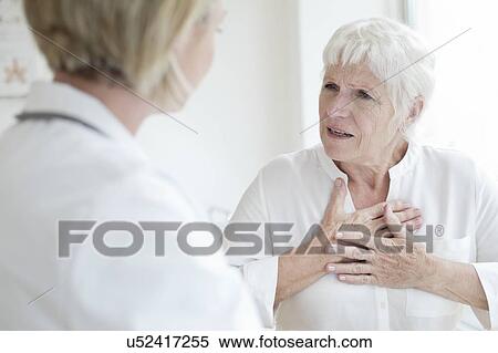 Senior talking to female doctor View Large Photo Image Stock Photography - Senior talking to female doctor. Fotosearch