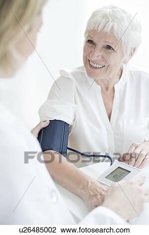 Senior woman having blood pressure taken View Large Photo Image Stock Image - Senior woman having blood pressure taken. Fotosearch