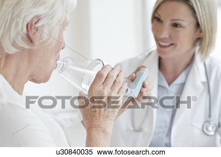 Senior woman using inhaler View Large Photo Image Stock Photography - Senior woman using inhaler. Fotosearch