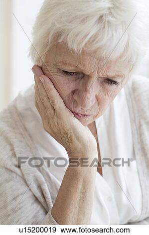 Senior woman with hand on chin View Large Photo Image Stock Photo - Senior woman with hand on chin. Fotosearch