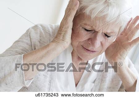 Stock Image - Senior woman with headache. Fotosearch