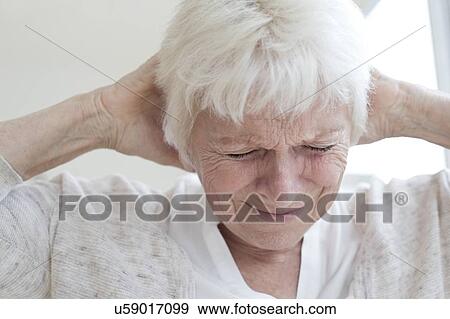 Stock Photo - Senior woman with headache. Fotosearch