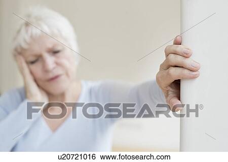 Stock Photograph - Senior woman with headache. Fotosearch