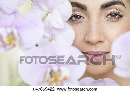 Woman and pink orchids View Large Photo Image Stock Image - Woman and pink orchids. Fotosearch