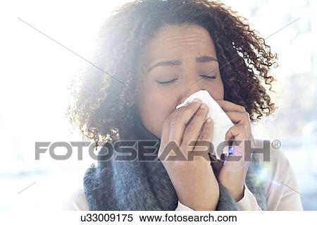 Woman blowing nose on tissue View Large Photo Image Stock Photography - Woman blowing nose on tissue. Fotosearch